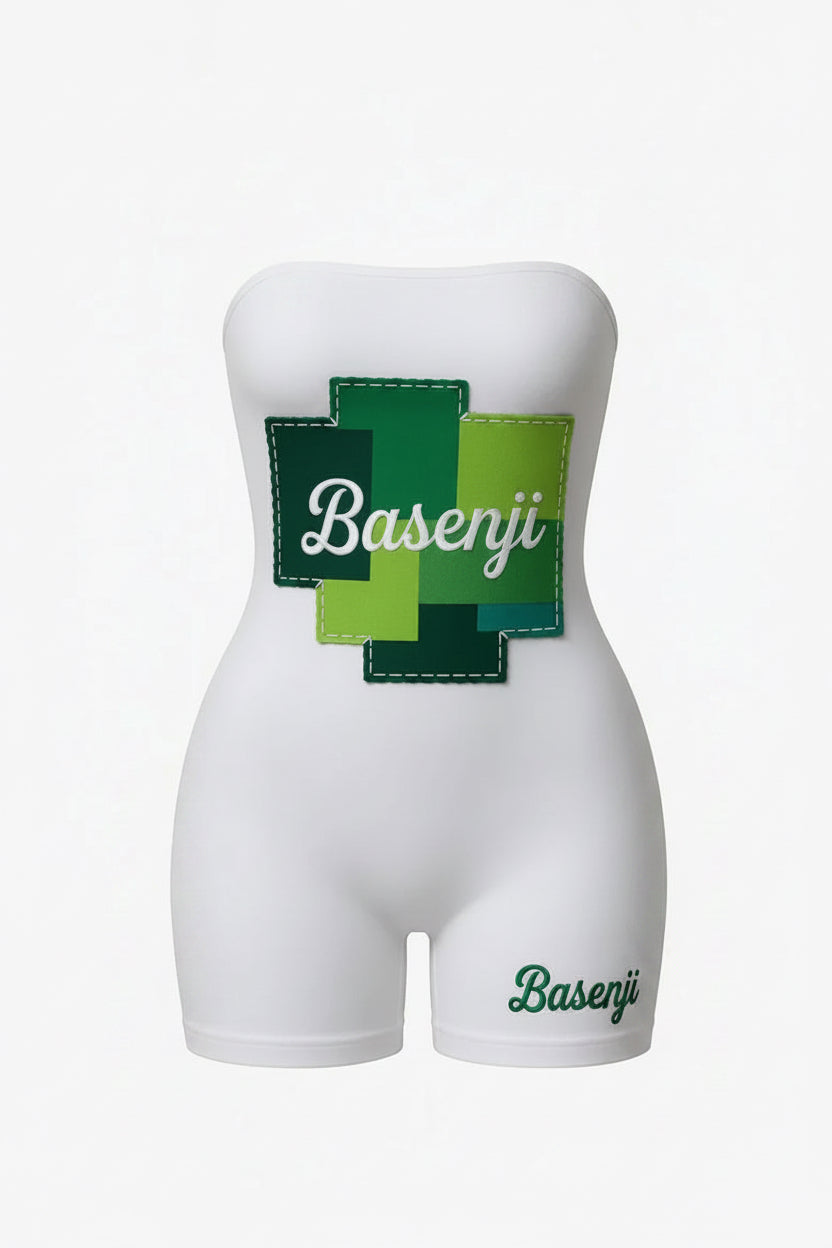 White romper with green and blue 'Basenji' patch on a white background