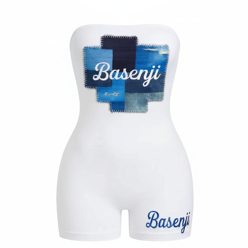 White romper with denim patchwork design and 'Basenji' branding on a white background